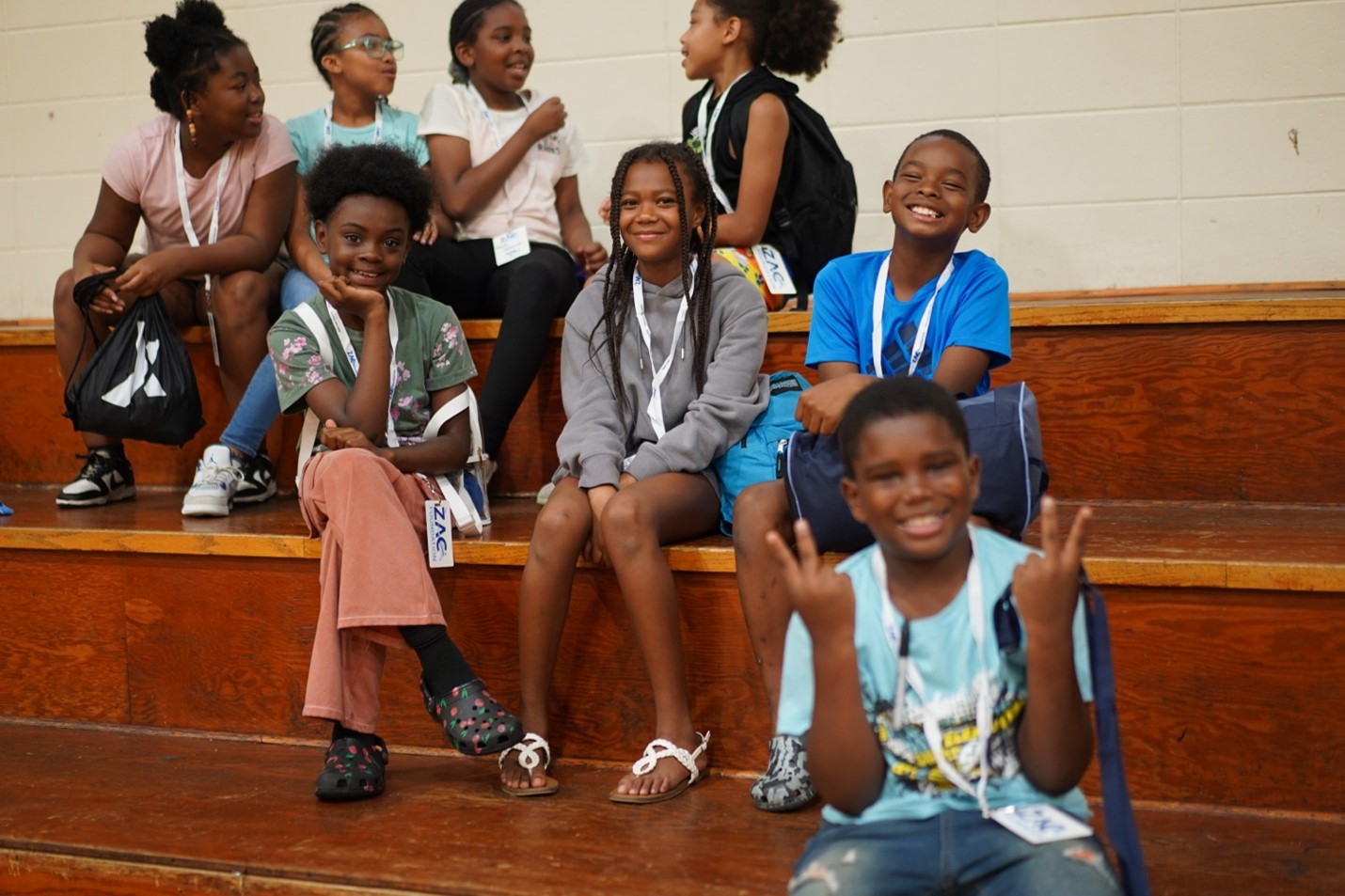 Students sit on bleachers and pose for the camera