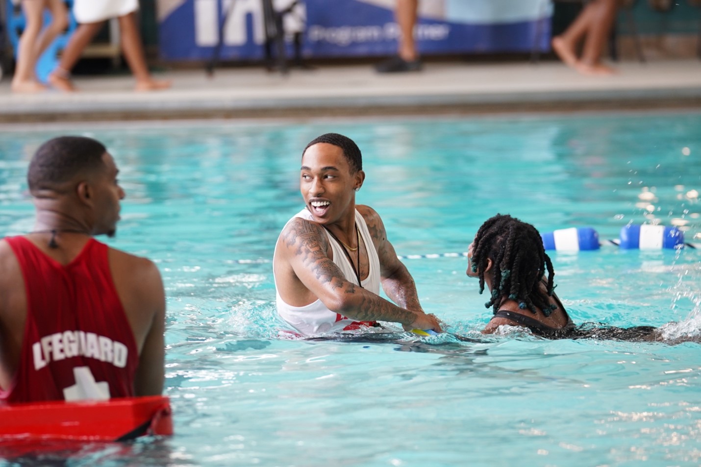 Lifeguard Helping Child Learn How to Float in Pool